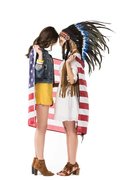 Вид збоку на двох бісексуальних дівчат хіпі, що тримають американський прапор ізольовано на білому — стокове фото