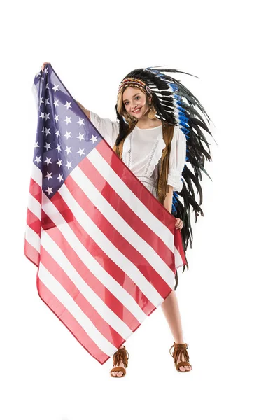 Full length view of happy hippie girl in indian headdress holding american flag isolated on white — Stock Photo