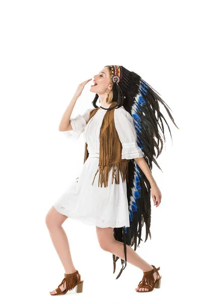 Full length view of hippie girl in indian headdress dancing isolated on white — Stock Photo