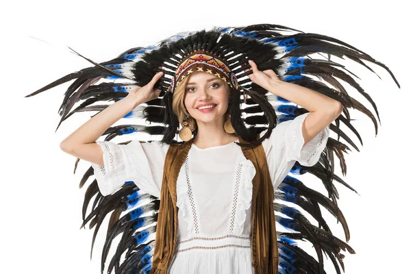 Smiling boho girl in indian headdress looking at camera isolated on white — Stock Photo