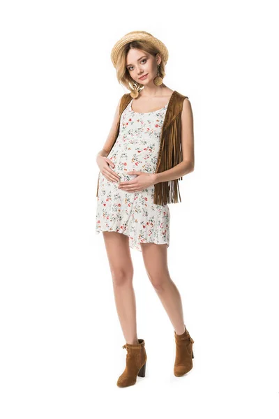 Full length view of pregnant hippie girl in straw hat touching belly isolated on white — Stock Photo