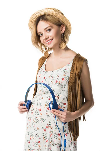 Pregnant woman holding headphones on belly isolated on white — Stock Photo