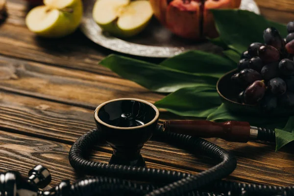 Selective focus of fruits and hookah on wooden surface — Stock Photo