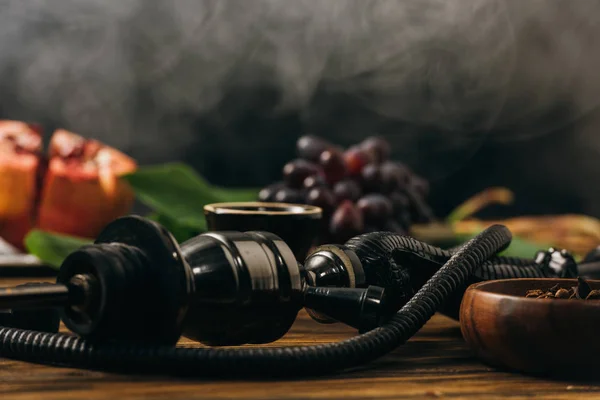 Selective focus of hookah and fresh fruits on wooden surface — Stock Photo