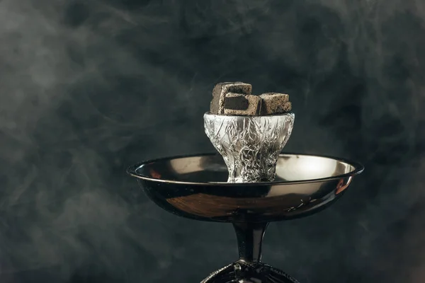 Hookah bowl with coals in smoke on black — Stock Photo