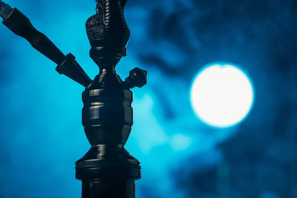 Black hookah stem and hose in blue smoke — Stock Photo