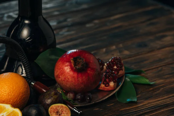 Tasty exotic fruits with hookah on wooden surface — Stock Photo