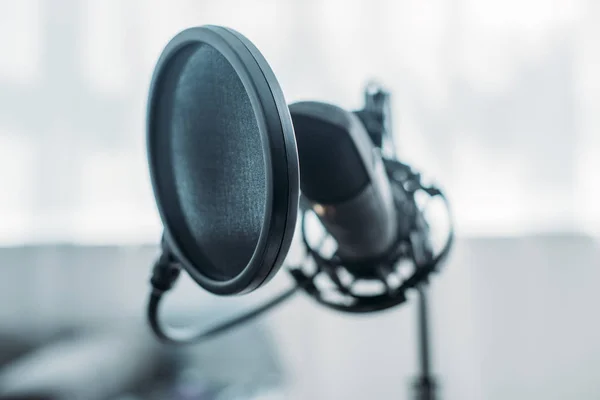 Selective focus of microphone with membrane in broadcasting studio — Stock Photo