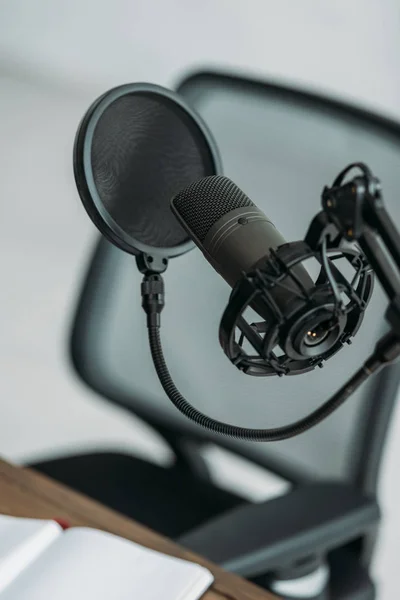 Professional microphone with membrane at workplace in broadcasting studio — Stock Photo