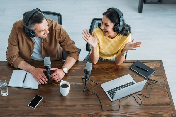 Overhead of two cheerful radio hosts recording podcast in radio studio — Stock Photo