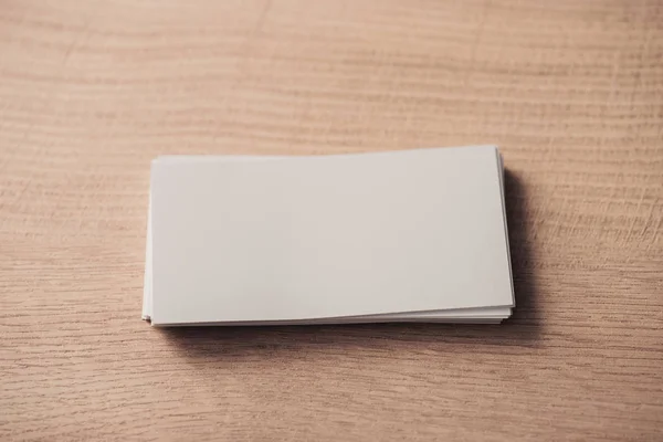 Stack of white empty business cards on wooden surface — Stock Photo