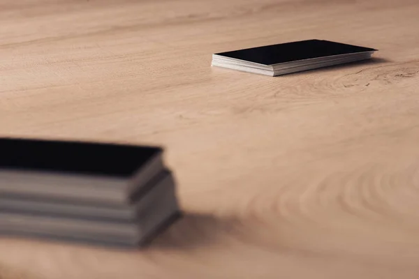 Stacks of black empty business cards on wooden table surface — Stock Photo