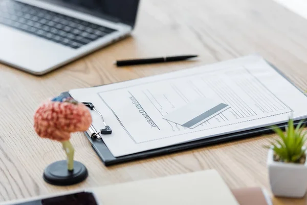 Laptop, insurance claim form and credit card on wooden table — Stock Photo