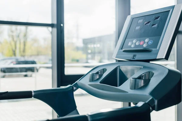 Modern treadmill with monitor near windows at sports center — Stock Photo