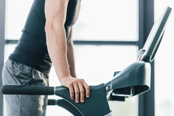 Cropped view of sportsman training on treadmill at sports center — Stock Photo