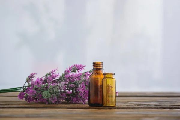 Heather flowers near empty glass jars on white background with copy space — Stock Photo