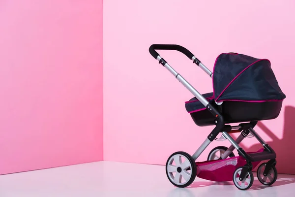 Baby carriage on pink and white with copy space — Stock Photo