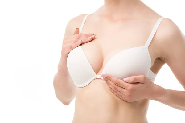 Частковий вигляд жінки в бюстгальтері робить самообстеження грудей ізольовано на білому — стокове фото