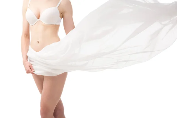 Partial view of sexy woman in underwear with white cloth isolated on white — Stock Photo