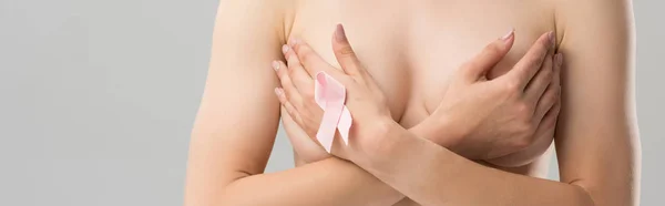 Panoramic shot of naked woman with pink ribbon isolated on grey — Stock Photo