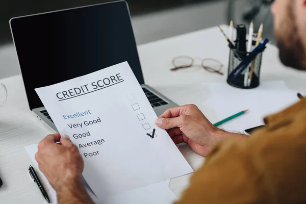 Selective focus of young adult man holding credit score — Stock Photo