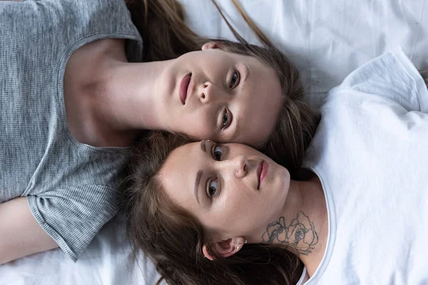 Top view of two lesbians lying in bed together — Stock Photo