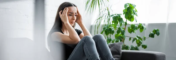 Panoramic shot of upset young woman suffering from depression at home — Stock Photo