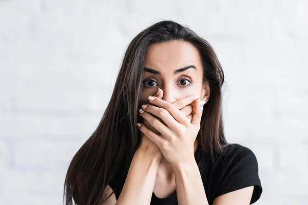 Joven asustado mirando a la cámara y cubriendo la cara con las manos mientras sufre de ataque de pánico — Stock Photo