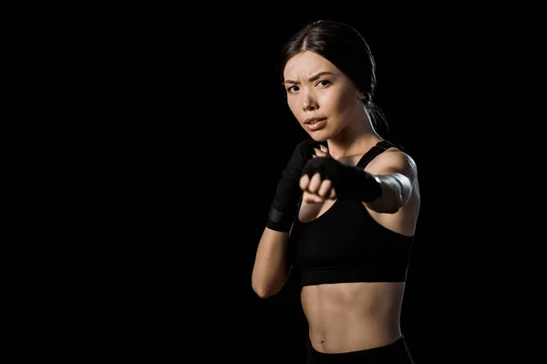 Selective focus of girl boxing in gloves isolated on black — Stock Photo