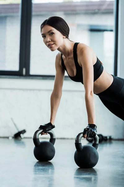 Beautiful woman  in sportswear exercising with dumbbells — Stock Photo