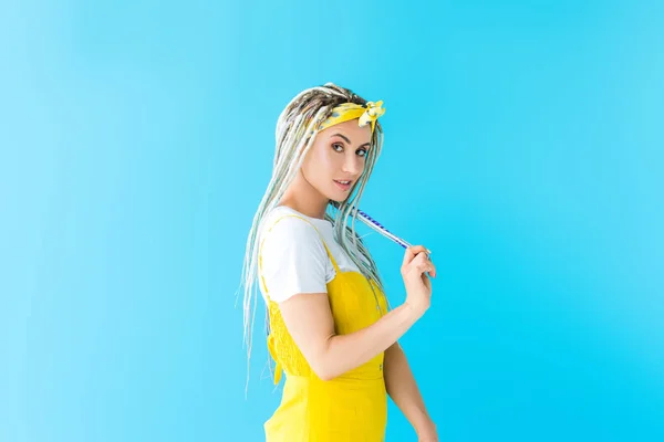 Beautiful girl with dreadlocks smiling and posing isolated on turquoise — Stock Photo