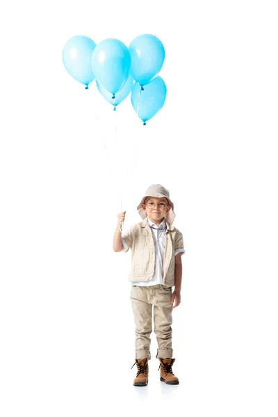 Vue pleine longueur de l'enfant explorateur dans des lunettes tenant des ballons bleus isolés sur blanc — Photo de stock