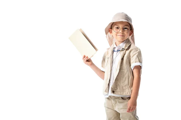 Lächelndes Forscherkind in Brille, Buch in der Hand und Kamera isoliert auf Weiß — Stockfoto