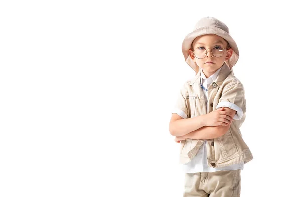 Pensive explorer boy in hat and glasses with crossed arms isolated on white — Stock Photo