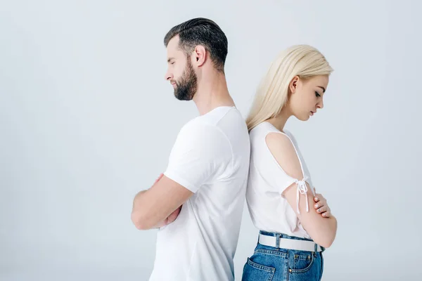 Homme et jeune femme debout dos à dos avec les bras croisés isolés sur gris — Photo de stock