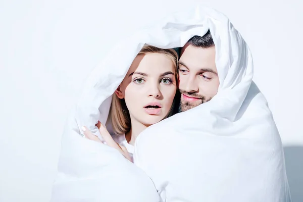 Girlfriend and boyfriend covered in blanket on white — Stock Photo