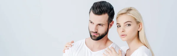 Panoramic shot of beautiful girl embracing man and looking at camera isolated on grey — Stock Photo