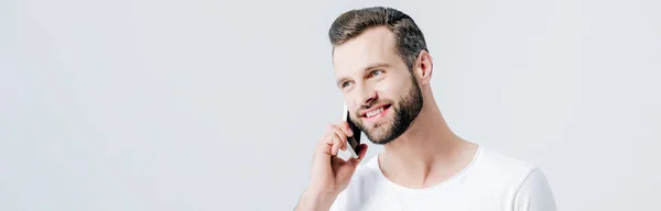 Panoramic shot of happy man talking on smartphone isolated on grey — Stock Photo