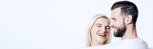 Panoramic shot of happy girlfriend and boyfriend covered in blanket isolated on white — Stock Photo