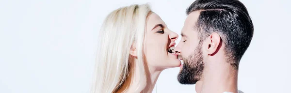 Panoramic shot of young woman biting nose of man isolated on white — Stock Photo
