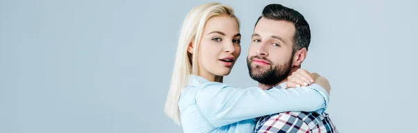 Panoramic shot of beautiful young couple hugging isolated on grey — Stock Photo