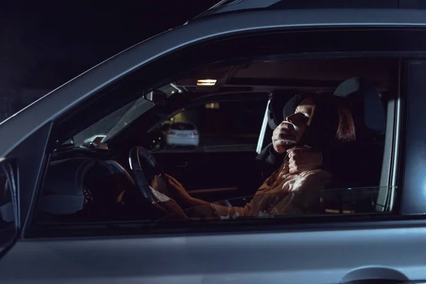 Ladrón atacando hermosa mujer asustada en el automóvil por la noche - foto de stock
