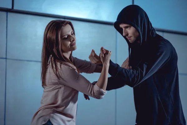 Beautiful woman fighting with thief in underpass — Stock Photo