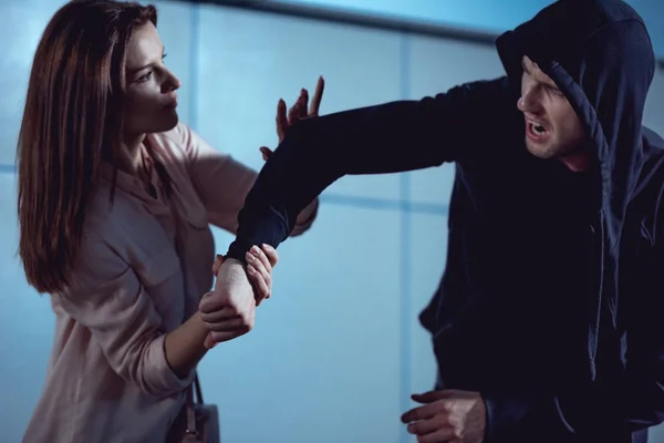 Beautiful woman fighting with thief in underpass — Stock Photo