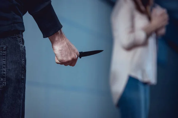 Selective focus of thief with knife standing near woman — Stock Photo