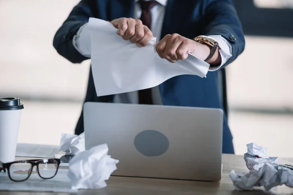 Ausgeschnittener Blick auf Geschäftsmann, der im Amt Papier zerreißt — Stockfoto