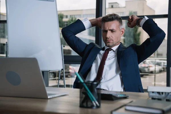 Selective of handsome businessman looking at laptop in office — Stock Photo