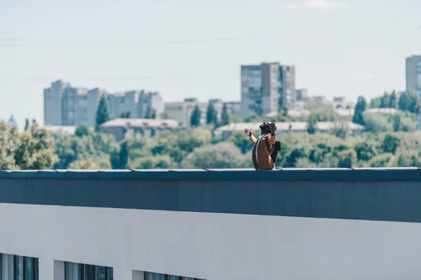 Afro-americano homem gesticulando com as mãos levantadas enquanto em pé no telhado do edifício — Fotografia de Stock