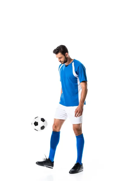 Guapo jugador de fútbol entrenamiento con pelota aislado en blanco - foto de stock