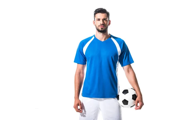 Jugador de fútbol sosteniendo la pelota y mirando a la cámara aislado en blanco - foto de stock